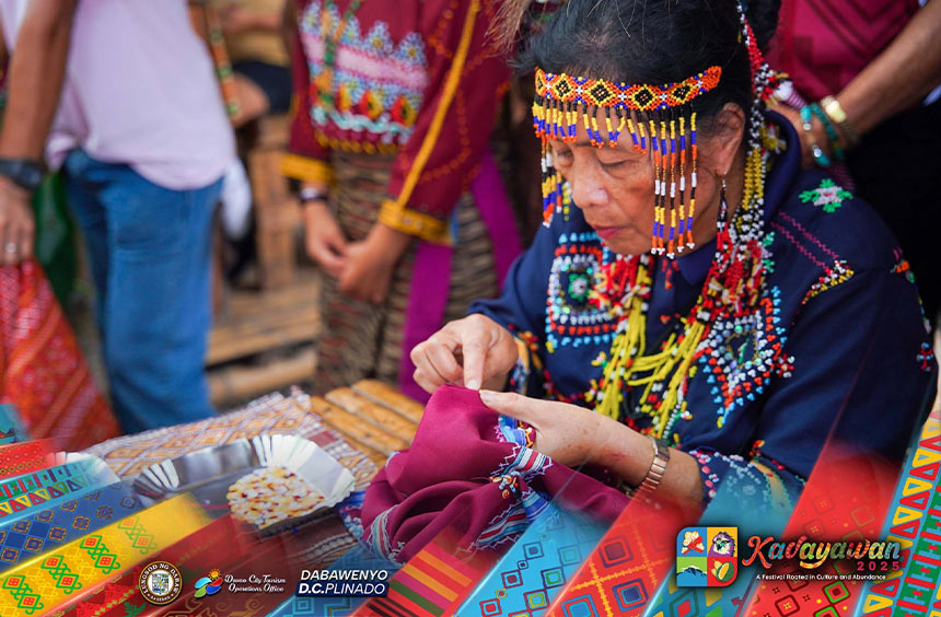 Tribal elder demonstrating beadwork on woven cloth during a Kadayawan Festival cultural showcase