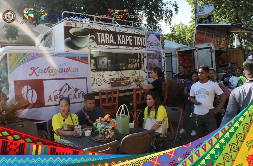Visitors dining beside a coffee food truck at a Kadayawan Festival food fair in Davao