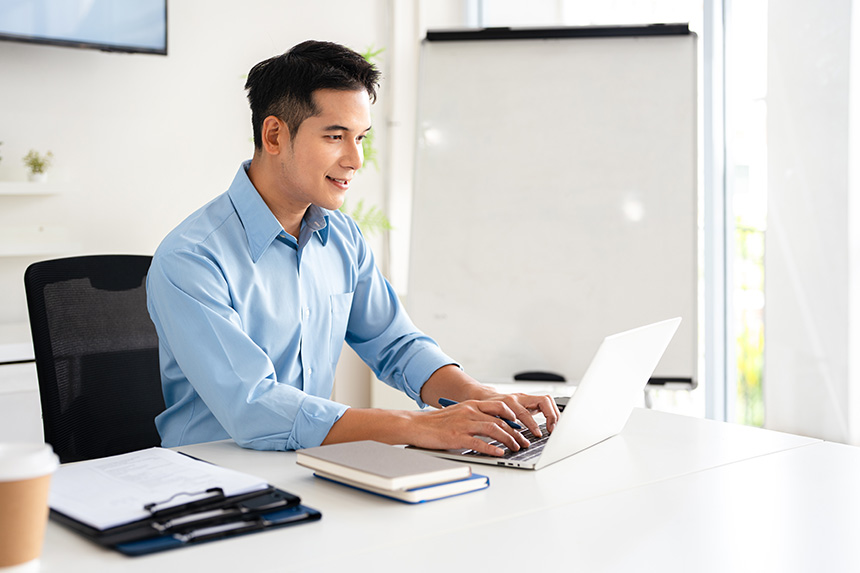 Person using a laptop to check their TIN application status online