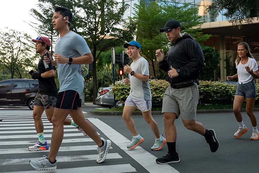group of runners sprinting side by side on their designated trail.