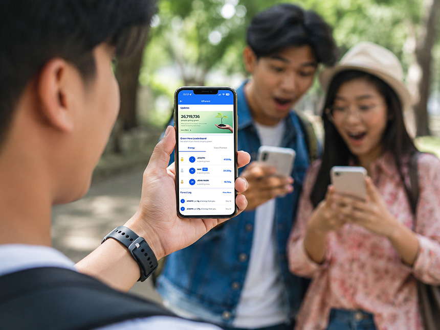 Person showing a smartphone with the GForest app to friends.