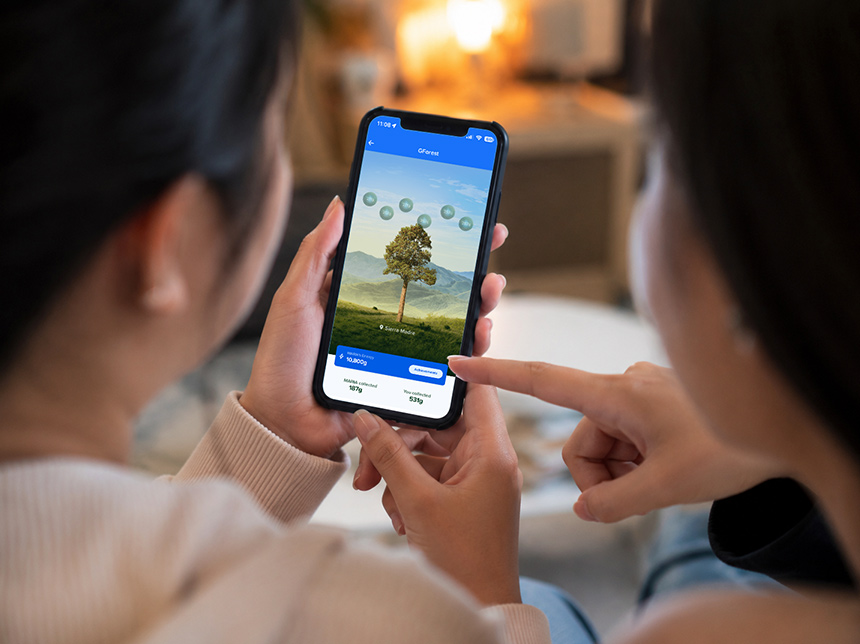 Two people viewing the GForest app together on a smartphone.