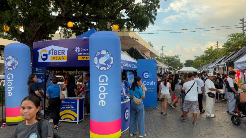 Globe GFiber and GCash booths surrounded by crowds at the outdoor Piña Festival 2026.