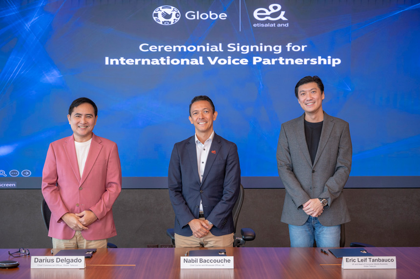 Globe and e& executives stand at the ceremonial signing for their international voice partnership.