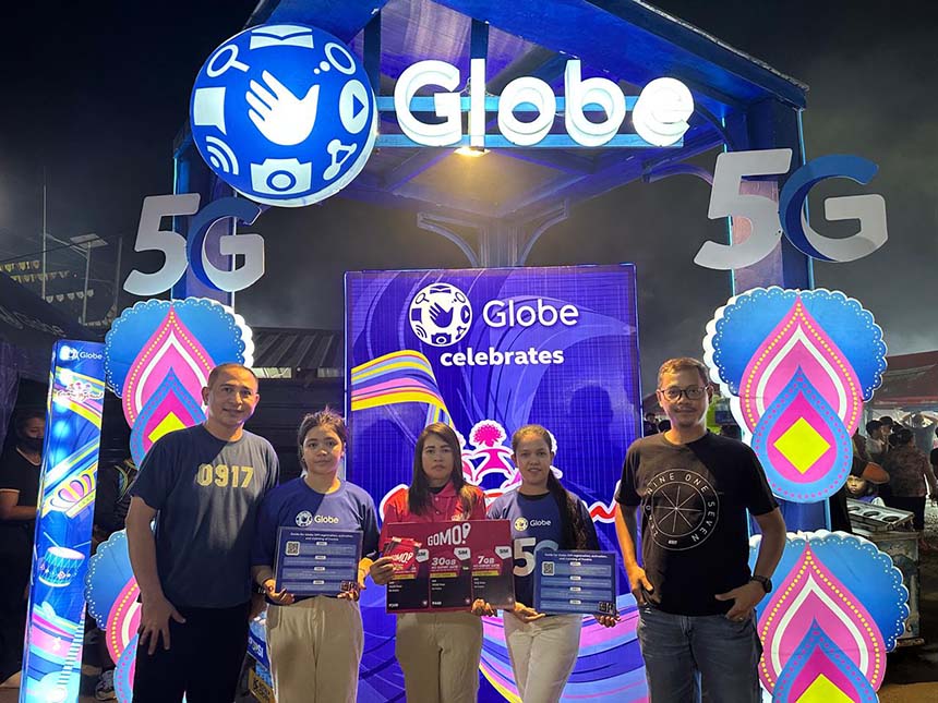 Globe representatives showcasing Globe and GOMO promos at the Sangyaw Festival.