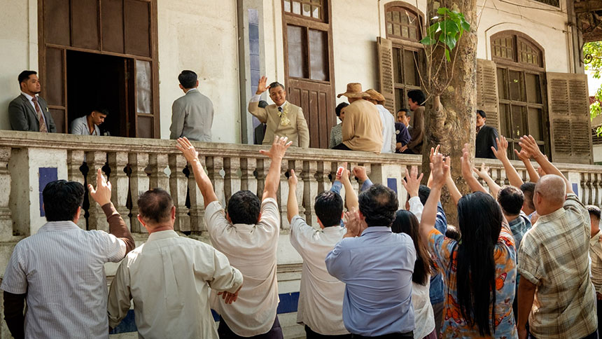 Manuel L. Quezon greets a crowd from a government building balcony in Quezon.