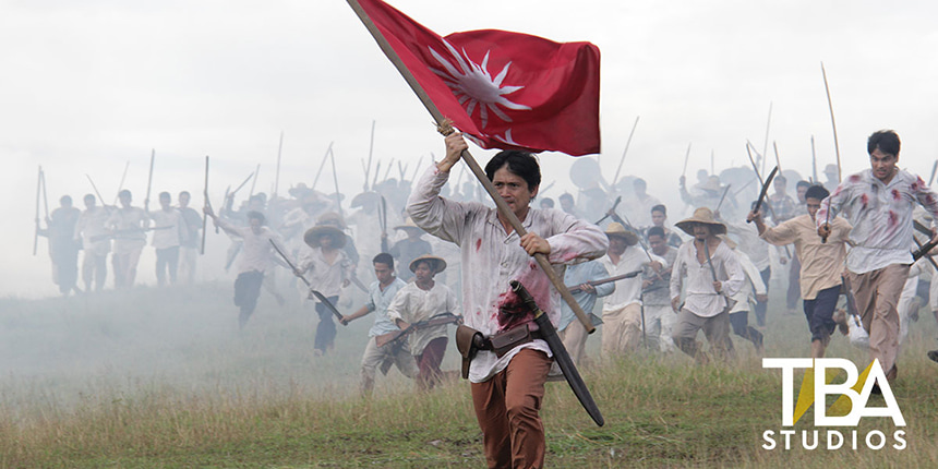 Andres Bonifacio leads Katipuneros into battle carrying a red flag in Bonifacio: Ang Unang Pangulo.