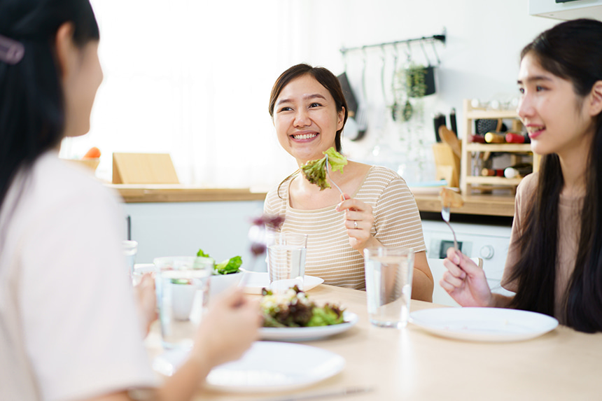 Friends eating a plant-forward meal together at home.