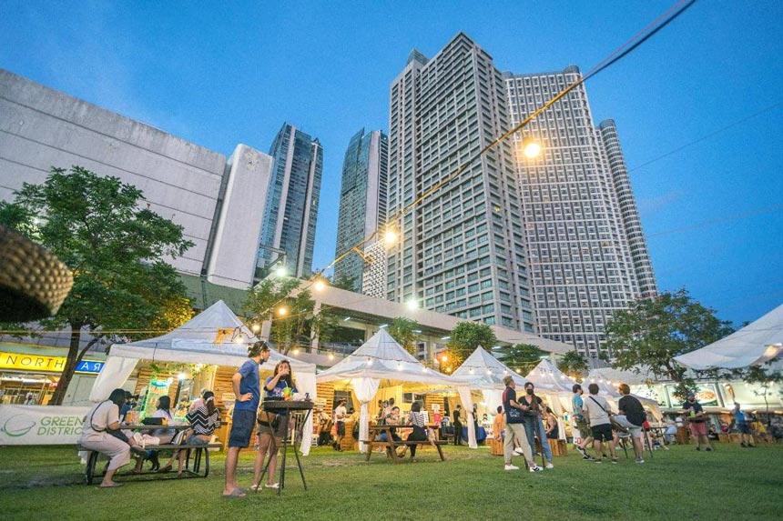 People enjoying the Greenfield Weekend Market at Greenfield District Central Park.