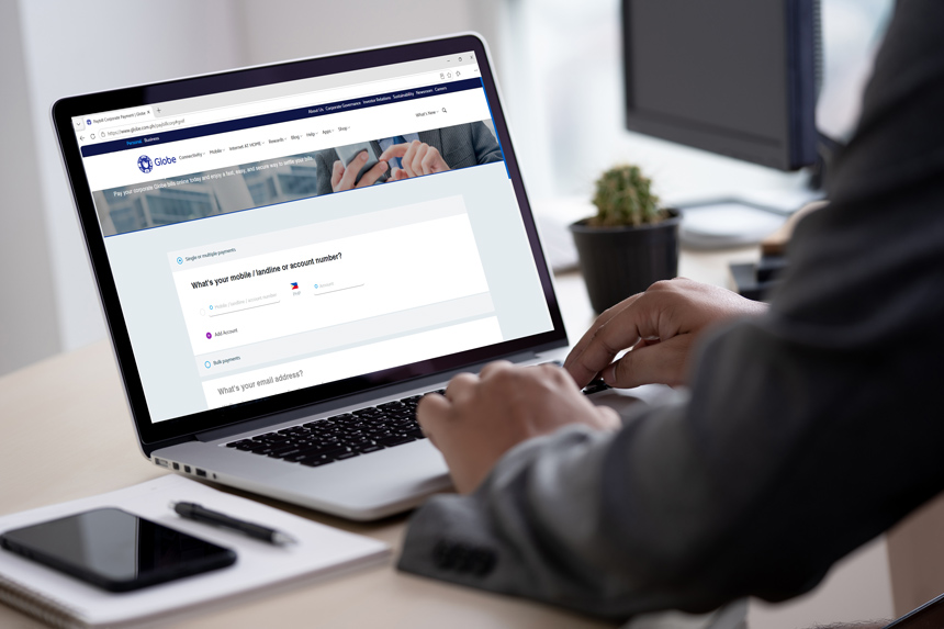 Person using a laptop to access an online corporate bill payment portal.