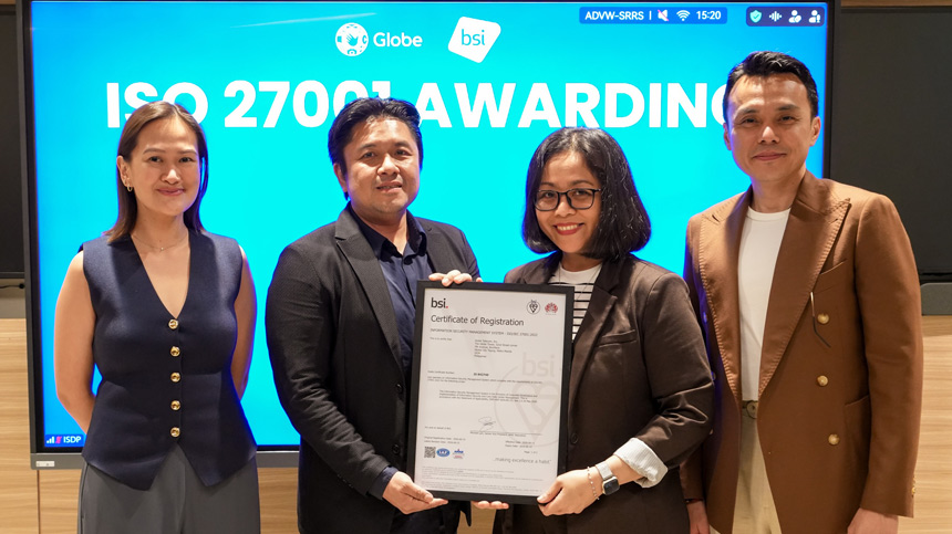 Four Globe and BSI executives pose with a framed ISO 27001 Certificate of Registration.