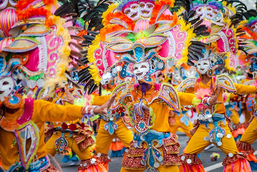 MassKara dancers in colorful costumes and masks.