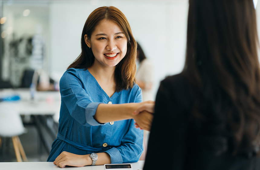 First-time jobseeker shakes a job interviewer's hand.