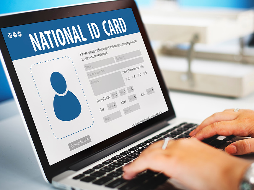 Laptop screen shows National ID graphic design concept.