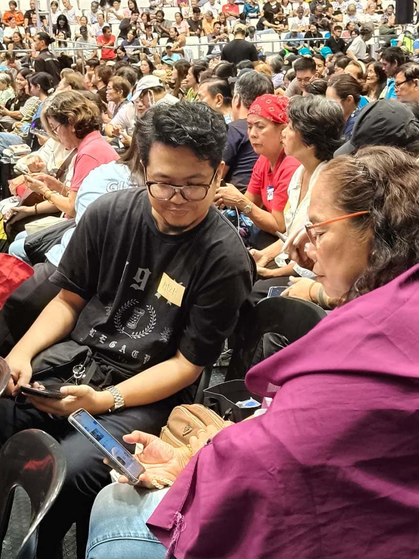 Globe volunteers assist senior citizens on smartphone navigation during the Senior Digizen workshop.