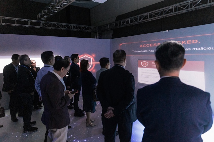 Executives view interactive cybersecurity simulation in Globe Experience Room.
