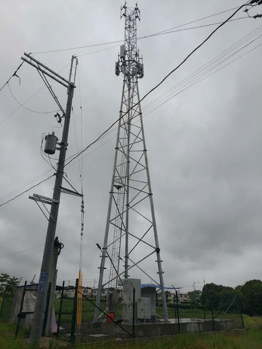 Globe Telecom 5G cell tower and ground station facility in Bulacan standing next to utility poles.