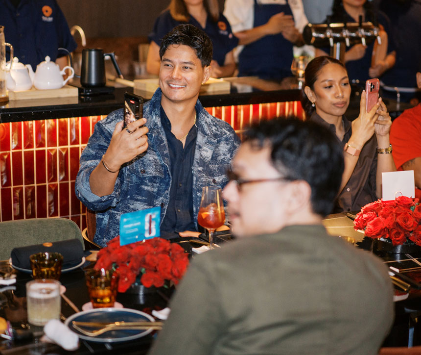 Guests capture moments on their phones during an exclusive Globe Platinum iPhone 18 launch dining event.